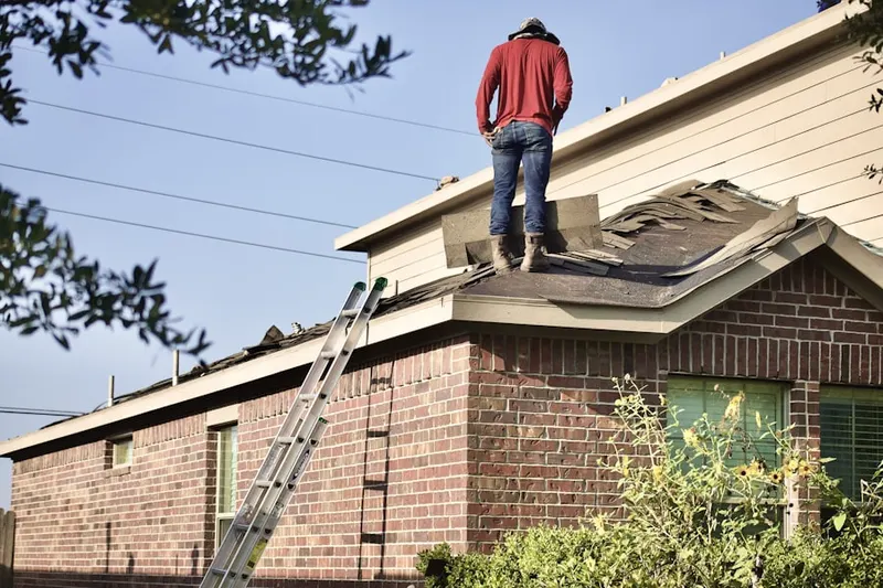 Professional roofer working on a residential roof in Oak Knoll